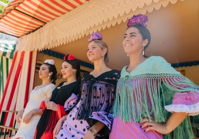 Smiling female flamenco dancers performing on stage Smiling female flamenco dancers performing on stage